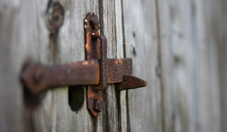 rusty latch on wooden gate