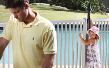 child trying to open pool gate, but unable to reach latch