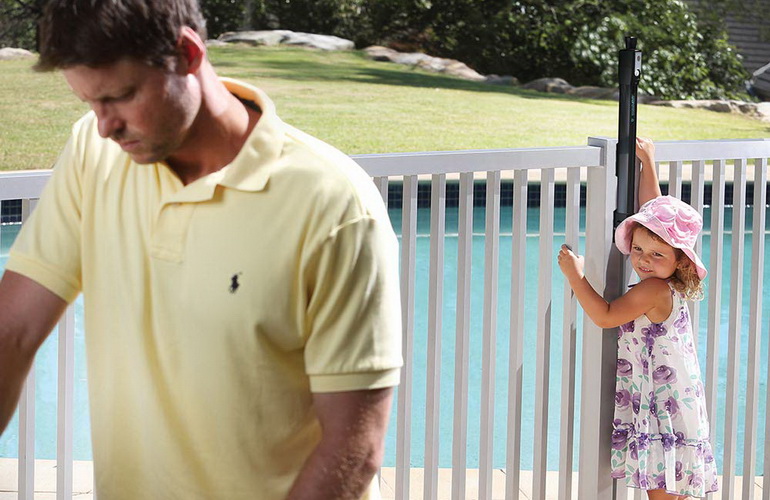 child trying to open pool gate, but unable to reach latch