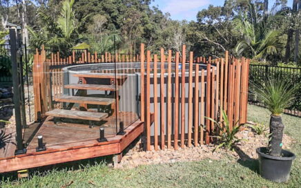 round outdoor pool with wooden fencing