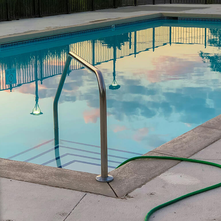 Reflection of sky and lights in a swimming pool.